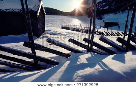Winter Landsgape With Wooden House And Traditional Norvegian Wooden Fence
