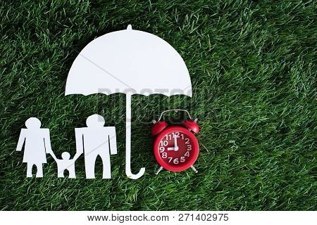 The Family Paper Cut And Red Alarm Clock Put Under The Umberella Paper Cut,sign And Symbol Of Safety