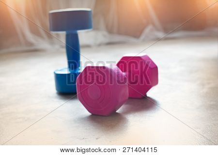 The Blurru Light Design Background Of Dumbbell Put On Ground Floor,the Accessory For Weight Lifting 