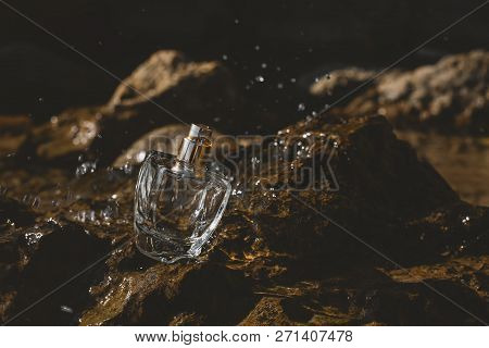 Perfume On The Stone With Splashes Of Water