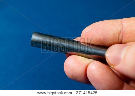 Tungsten Rod In The Hand. A Piece Of Tungsten For Experiments.