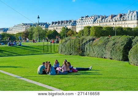Paris, France - September 7, 2018: Unidentified Young People Rest On Green Lawn In Park Near Archite