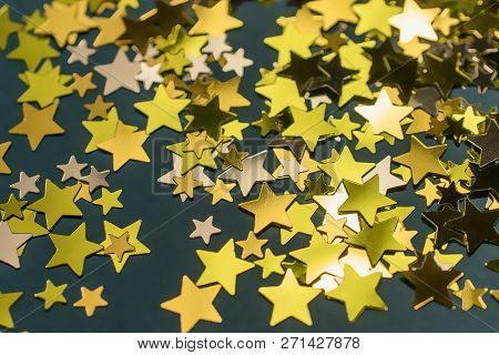 Golden Confetti Stars Scattered On The Surface.