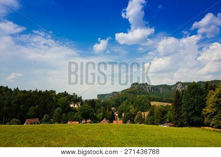 Rathen, Saxon Switzerland National Park. View Of German Houses On Blue Sky Background With Clouds. R