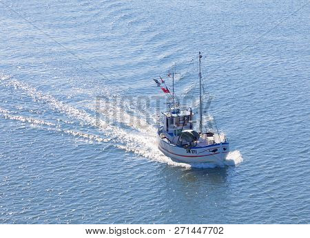 Grisslehamn, Sweden - Jul 13, 2018: Small Fishing Boat On The Blue Sea Heading Back After Taking Up 
