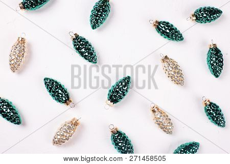 Christmas Or New Year Composition. Decorative Gold And Silver Pine Cones On Whitetextured Background