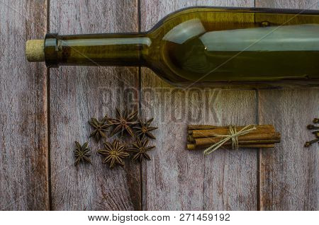 Hot Mulled Wine Drink With Lemon, Apple, Cinnamon, Anise And Other Spices In A Glass Cup Between Fir