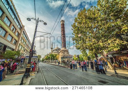 Istanbul, Turkey: The Shopping Divan Yolu Street With The Famous Roman Column Of Constantine On Octo