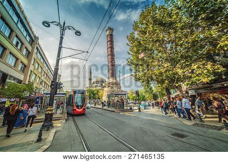 Istanbul, Turkey: The Shopping Divan Yolu Street With The Famous Roman Column Of Constantine On Octo