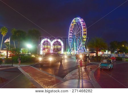 Orlando, Florida.  November 02, 2018. Main Entrance Of Old Town With Arches And Colorful Wheel In Ki
