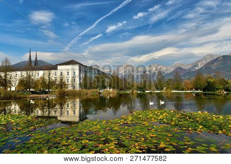 View Of The Admont Abbey And The Lily-covered Pond With A Couple Of Swans On A Sunny Autumn Day. Tow