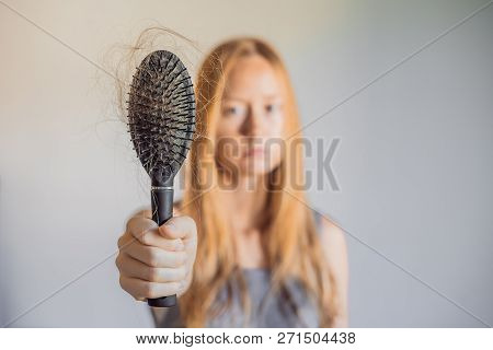 Hair Loss In Women Concept. A Lot Of Lost Hair On The Comb