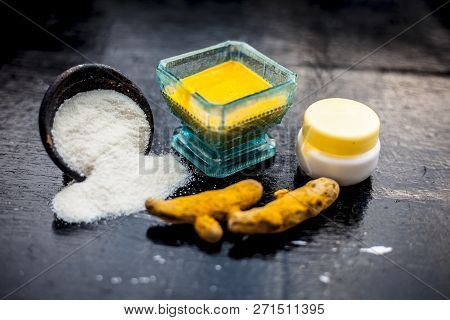 Close Up Of Face Pack Of Rice Flour With Fresh Face Cream And Turmeric Powder On Wooden Surface In A