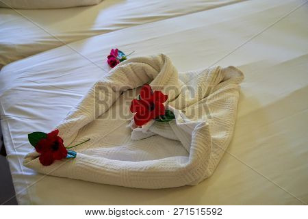 Creative Composition Of White Towels On The Bed Laid Out In The Form Of A Heart