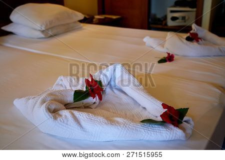 Creative Composition Of White Towels On The Bed Laid Out In The Form Of A Heart