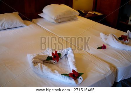 Creative Composition Of White Towels On The Bed Laid Out In The Form Of A Heart