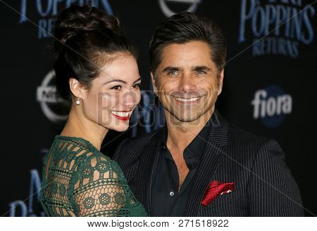 Caitlin Mchugh and John Stamos at the World premiere of Disney's 'Mary Poppins Returns' held at the Dolby Theatre in Hollywood, USA on November 29, 2018.