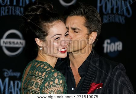 Caitlin Mchugh and John Stamos at the World premiere of Disney's 'Mary Poppins Returns' held at the Dolby Theatre in Hollywood, USA on November 29, 2018.
