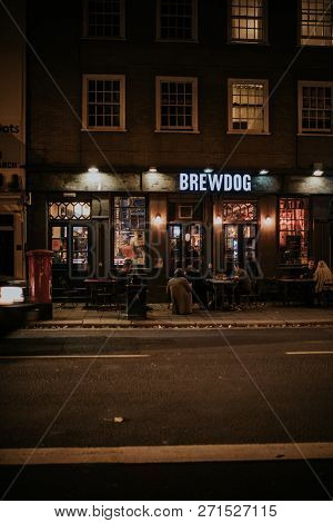 Brighton, England - October 26th, 2018: Night View Of Brewdog Brewery Pub Facade With People Sitting