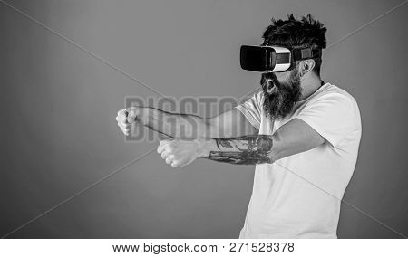 Virtual Racing Concept. Man With Beard In Vr Glasses Driving Car, Red Background. Guy Play Racing Ga