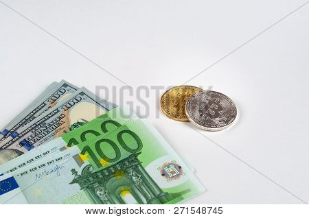 Bitcoins Lie On A Light Background With Dollars And Euro Close-up