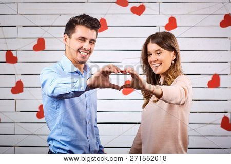Young Happy Couple With Heart In Hands Onbackground