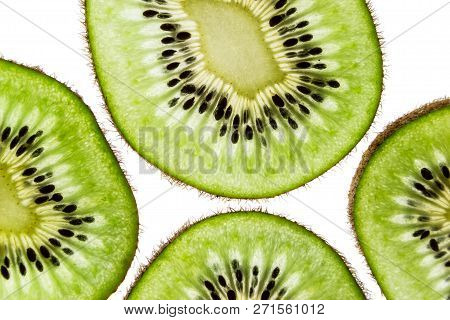 Sliced Kiwifruit Rings On White Background Top View Macro