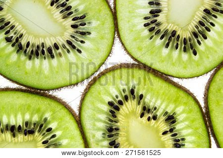 Sliced Kiwifruit Rings On White Background Top View Macro