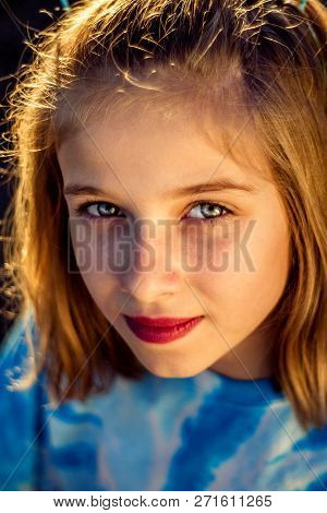 Late Afternoon, Golden Hour, Closeup Portrait Of A Preteen Girl.  Her Face Is Bathed In Yellow Light