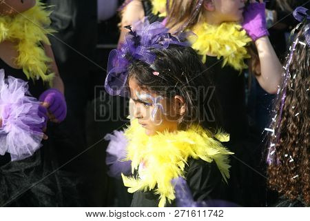 Paphos, Cyprus, March 12th, 2016: A Serious Looking Little Girl In Bright Costume Taking Part In Tra