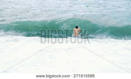 Male Tourist Dives Into A Big Sea Wave Covers Headlong, Slow Motion