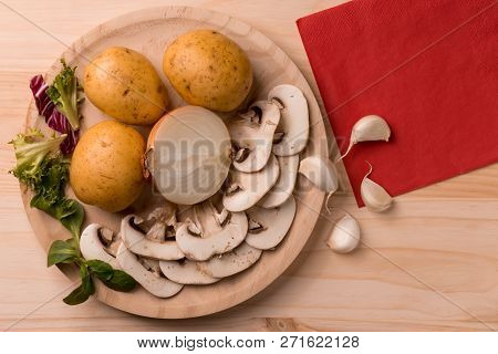 Appetizing Products For Cooking, Mushrooms, Potatoes, Onions, Garlic, Herbs On A Wooden Background W