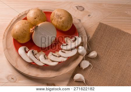 Appetizing Products For Cooking, Mushrooms, Potatoes, Onions, Garlic, Herbs On A Wooden Background W