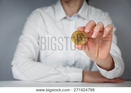 Golden Bitcoin In A Man Hand, Digitall Symbol Of A New Virtual Currency