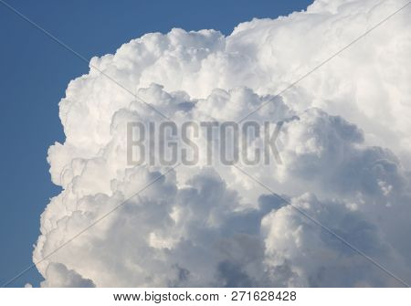 Big Soft White Cumulonimbus Cloud In Blue Sky
