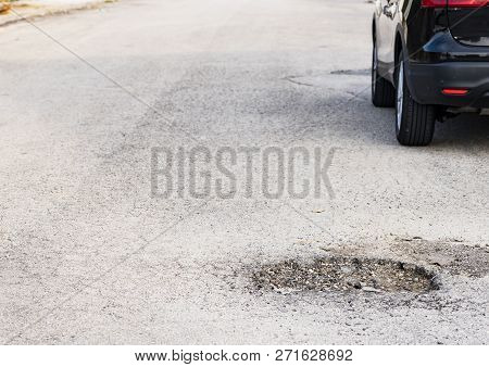 Close-up Of Damaged Street With Pot Hole