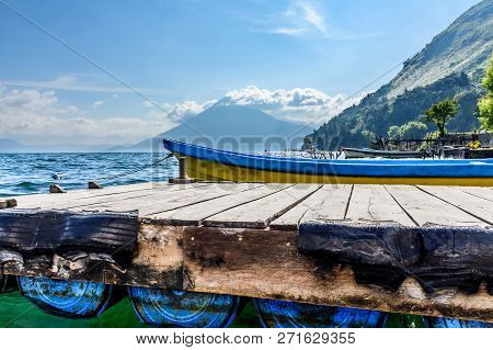 Boat Docked At Jetty With San Pedro Volcano Behind On Lake Atitlan, Guatemala.