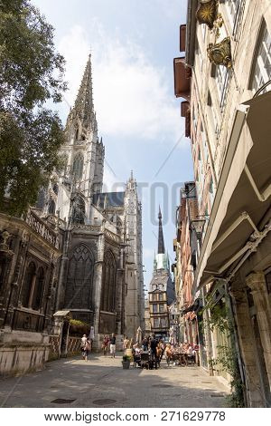Rouen, France - August 19, 2018: Residents Of The City And Tourists Relax In A Cafe Near The Church 