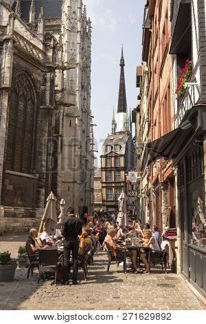 Rouen, France - August 19, 2018: Residents Of The City And Tourists Relax In A Cafe Near The Church 