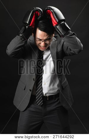 Asian Business Man In Suit And Boxing Gloves, Express His High Stressful And Unhappy, Losing In Comp