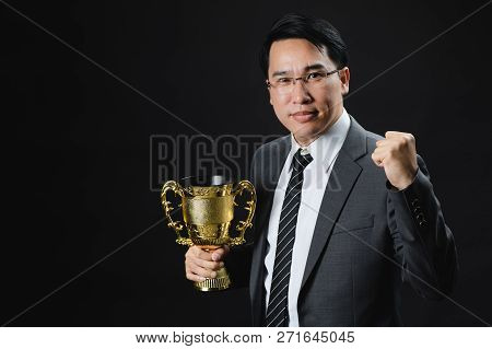 Asian Man In Formal Suit Holding And Rise Golden Trophy Cup, Reward Of Target Achievement Winner, Pr