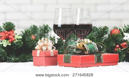 Two Red Wine Glasses Set Next To Red Gift Boxex On Snowy Table Prepare For Celabraion, Decorate With