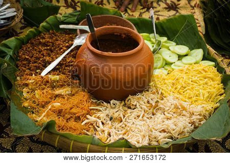 Rice Tumpeng Served In Big Bamboo Plate With Rice Chicken Noodle And Clay Pot In Central Java Indone