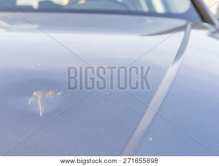 Close- Up Of Damaged And Scratched Car Engine Hood