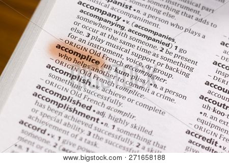 The Word Or Phrase Accomplice In A Dictionary Highlighted With Marker.