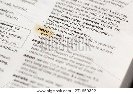 The Word Or Phrase Adze In A Dictionary Highlighted With Marker.