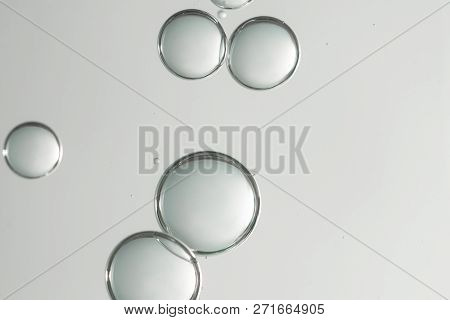 Beautiful Light Green Air Bubbles Flows Over A Blurred Background.
