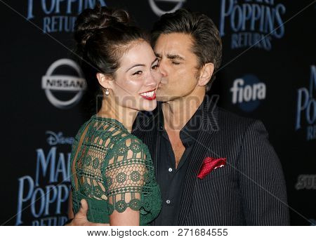 Caitlin Mchugh and John Stamos at the World premiere of Disney's 'Mary Poppins Returns' held at the Dolby Theatre in Hollywood, USA on November 29, 2018.