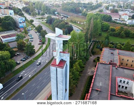 Koszalin, Poland - 13 September 2018 - Aerial view on Catholic Church tower with cross at Monte Cassino street