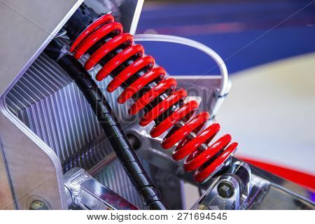 Red Motorcycle Shock Absorbers A Device For Absorbing Jolts And Vibrations.